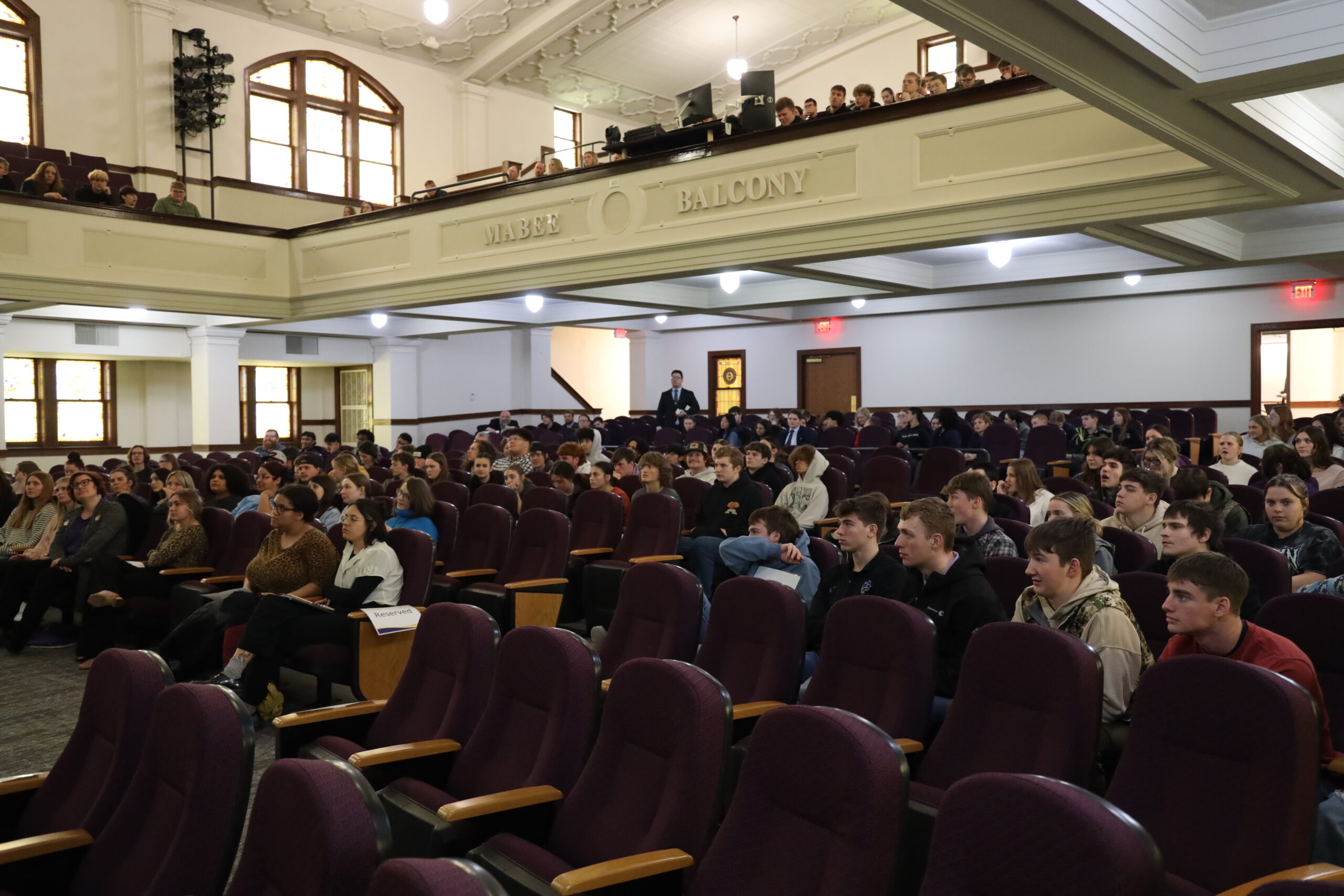 Crowd of people in seats in auditorium