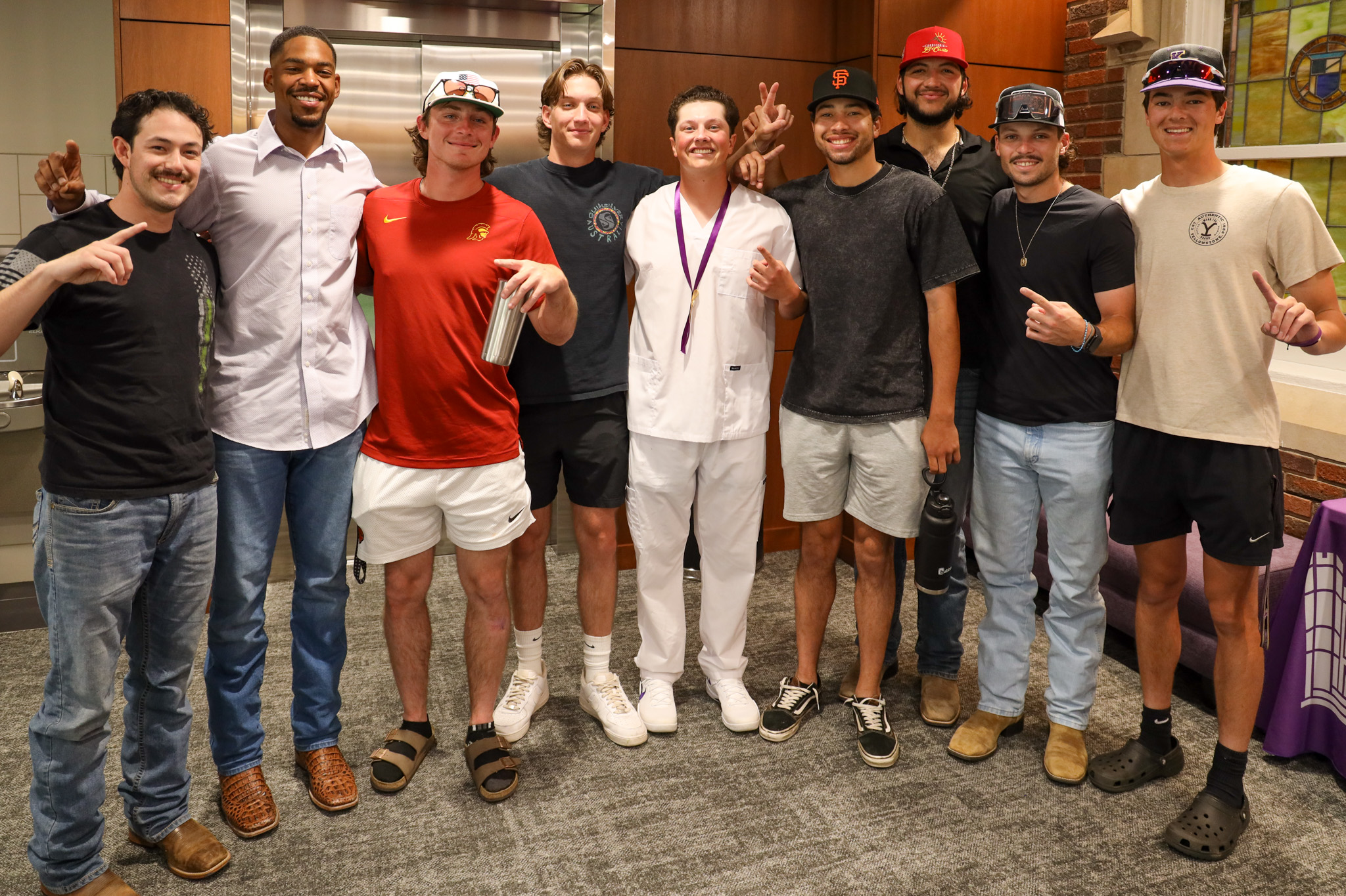 Friends surrounding male nursing graduate