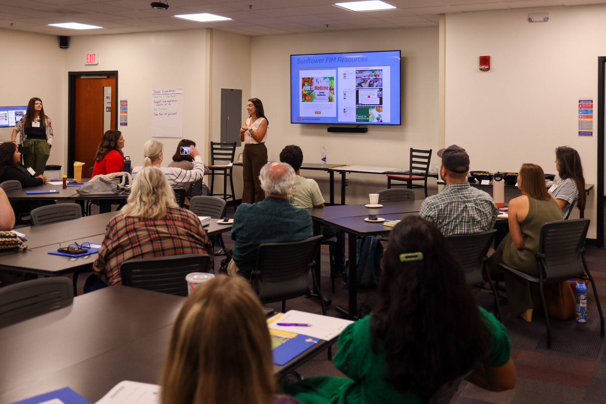 Woman standing in front of class speaking