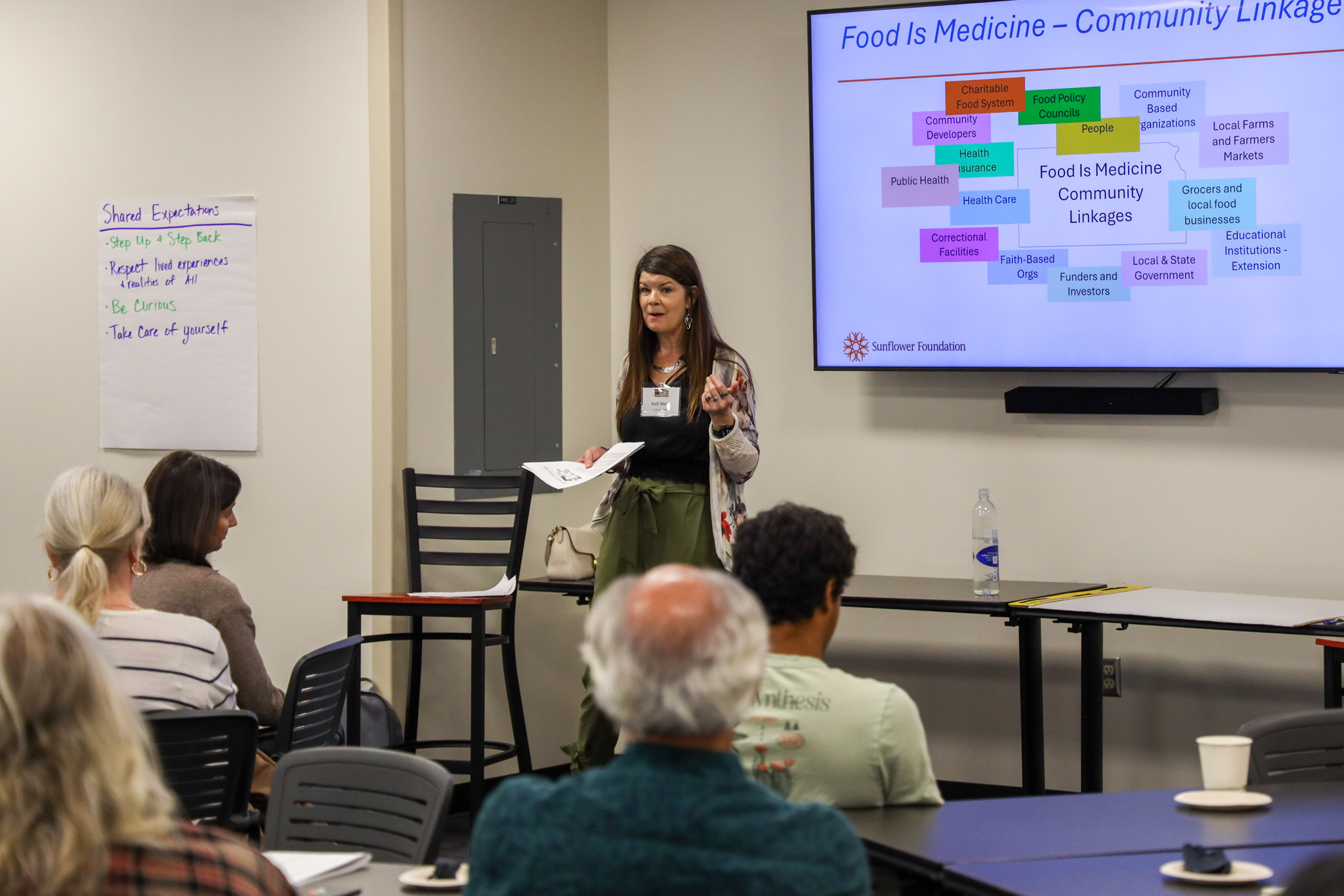 Woman standing in front of class speaking
