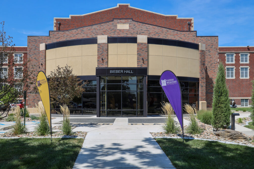 Photo of Bieber Hall with flags in front