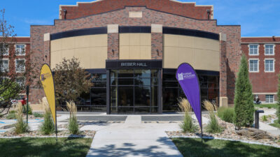 Photo of Bieber Hall with flags in front