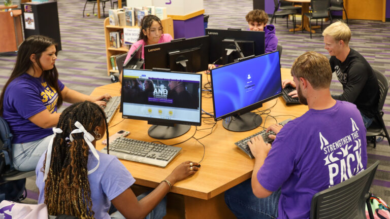 Group of students studying together in library