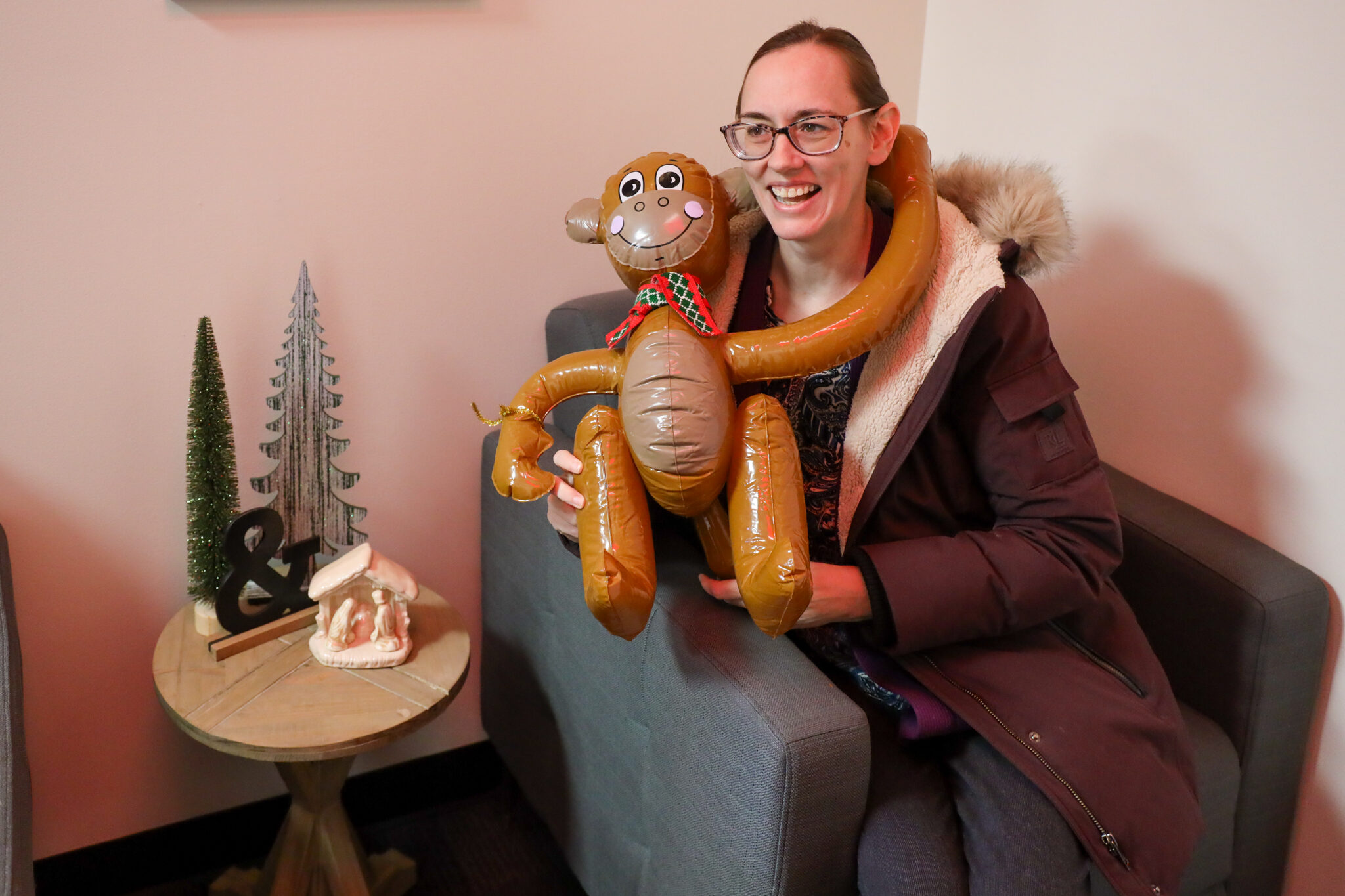 Woman hugging plastic monkey