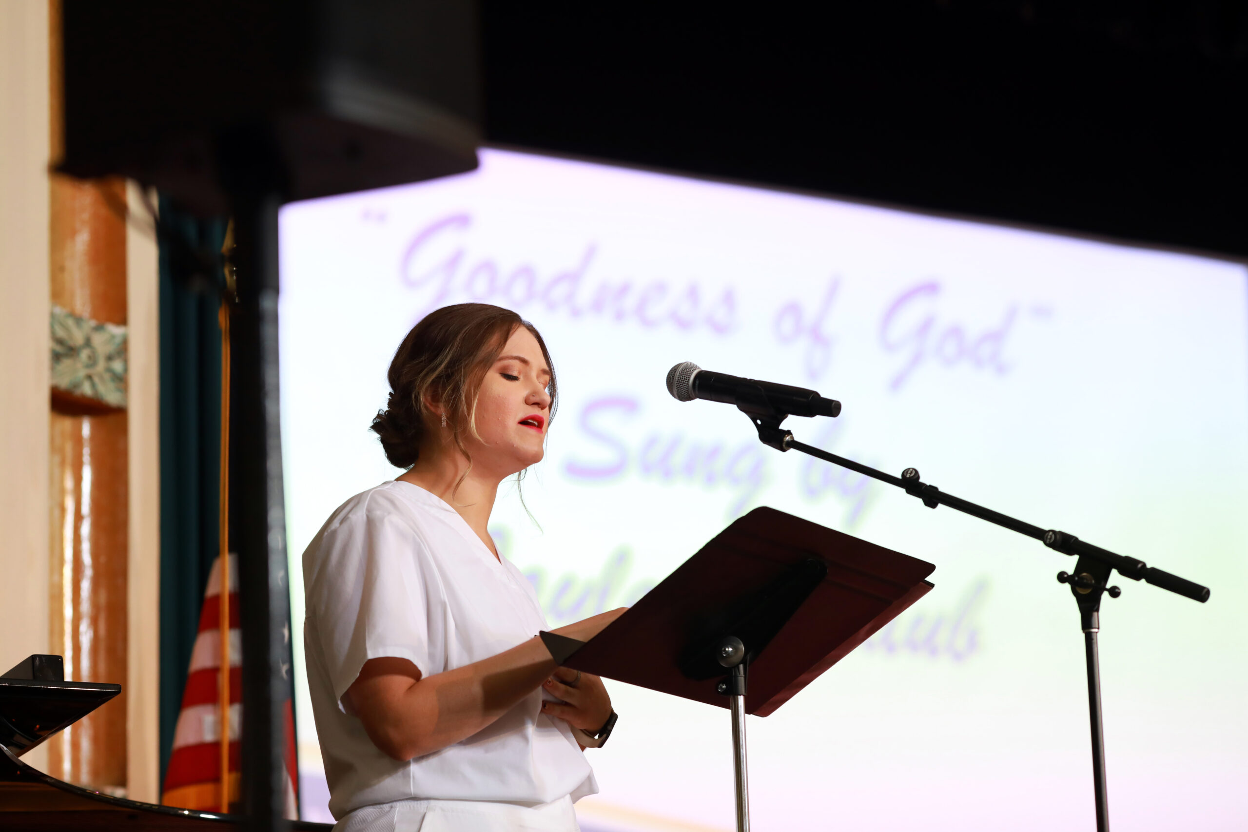 Female singing on a stage