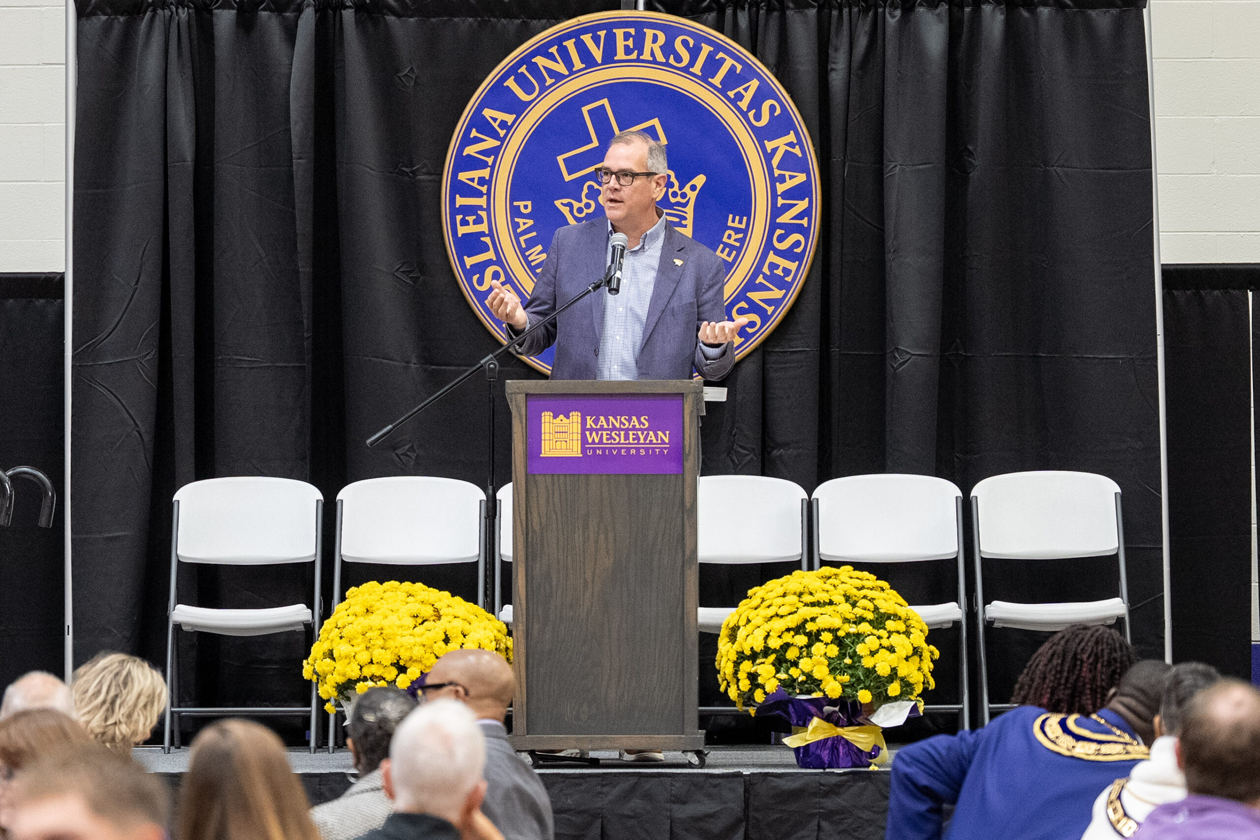 Man standing at podium speaking