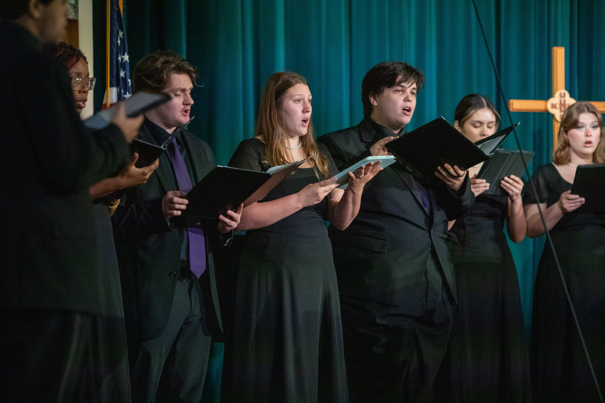 Group in black robes singing