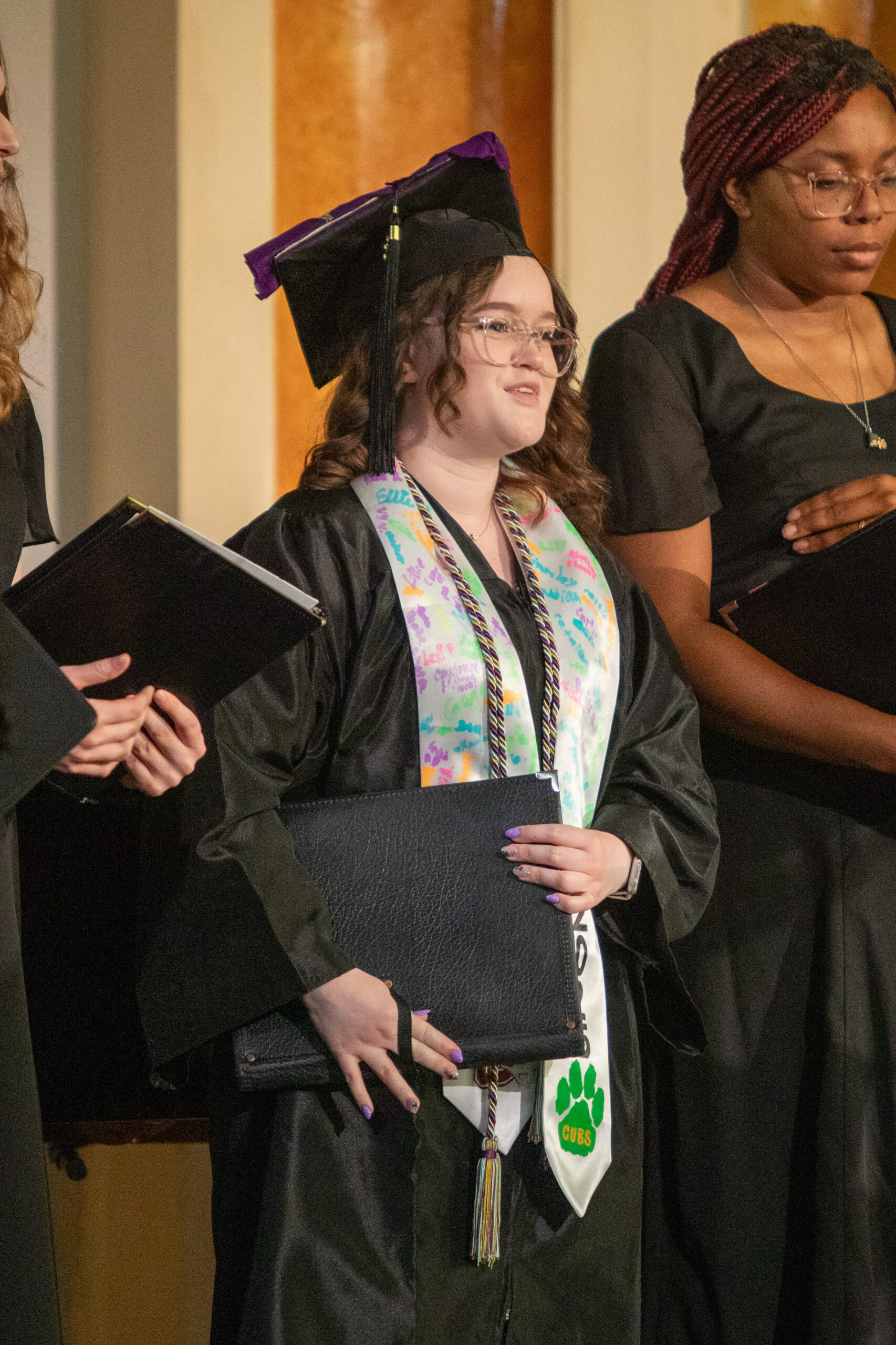 Females singing, black robes