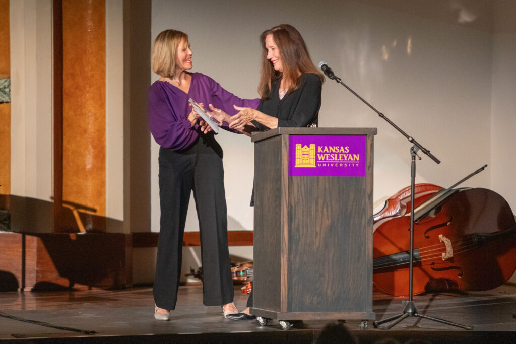 Woman accepting award from other woman