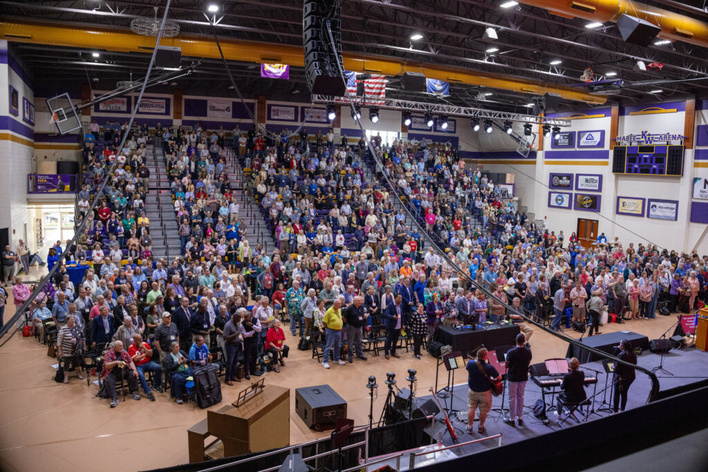 Wide-angle shot of capacity crowd in arena