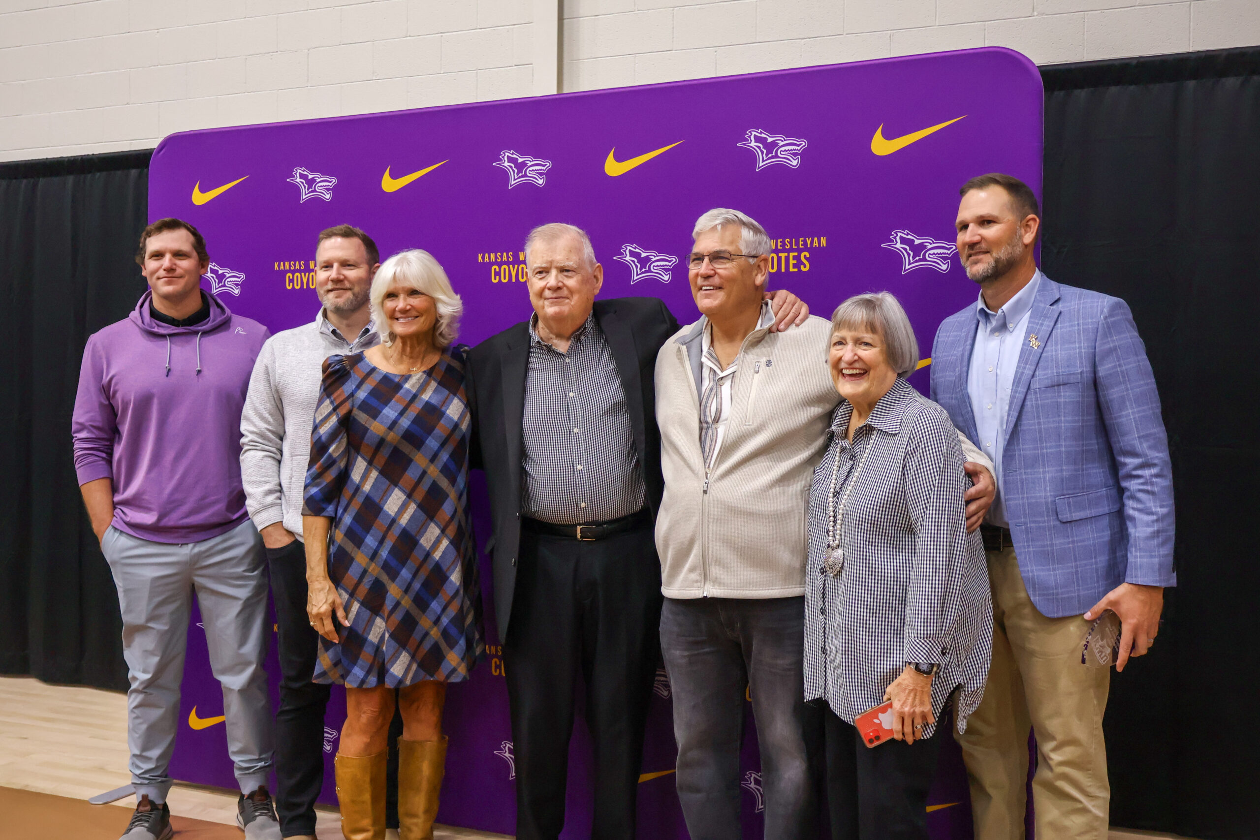 Group of various individuals in front of backdrop