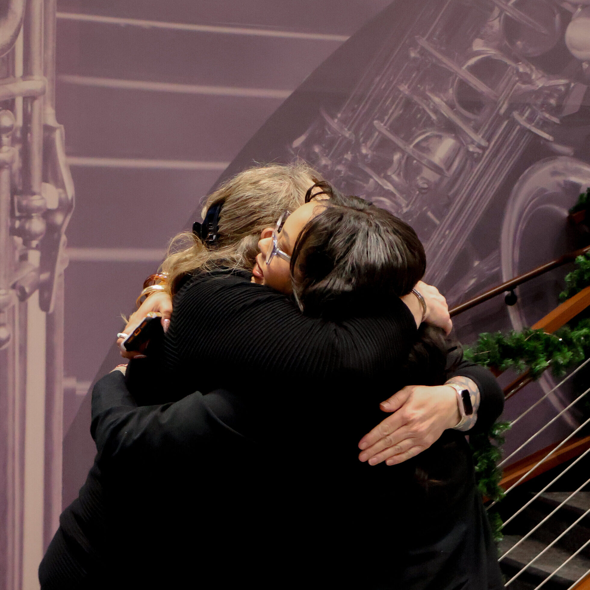 Graduate hugging other person