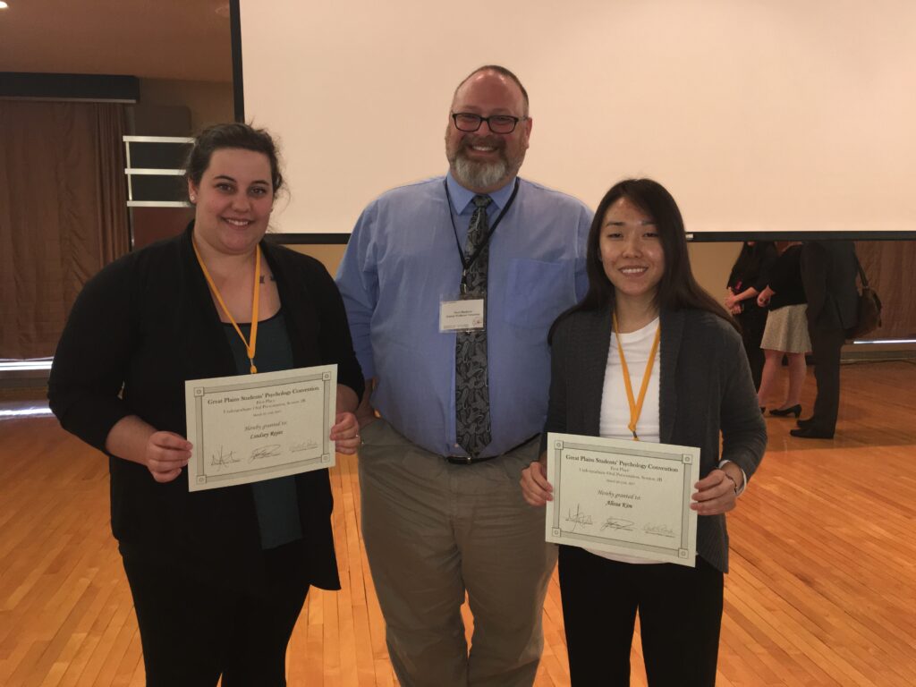 Two students with professor