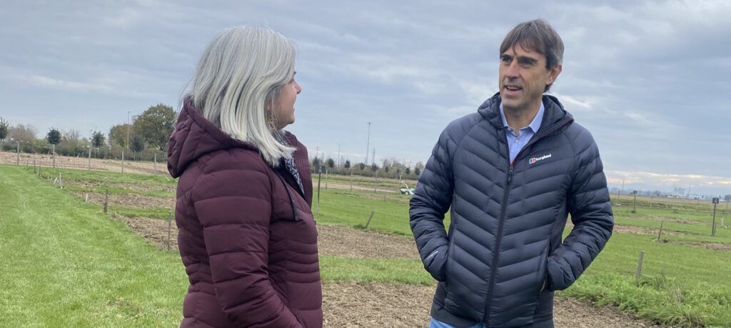 Man and woman standing next to each other on farmland
