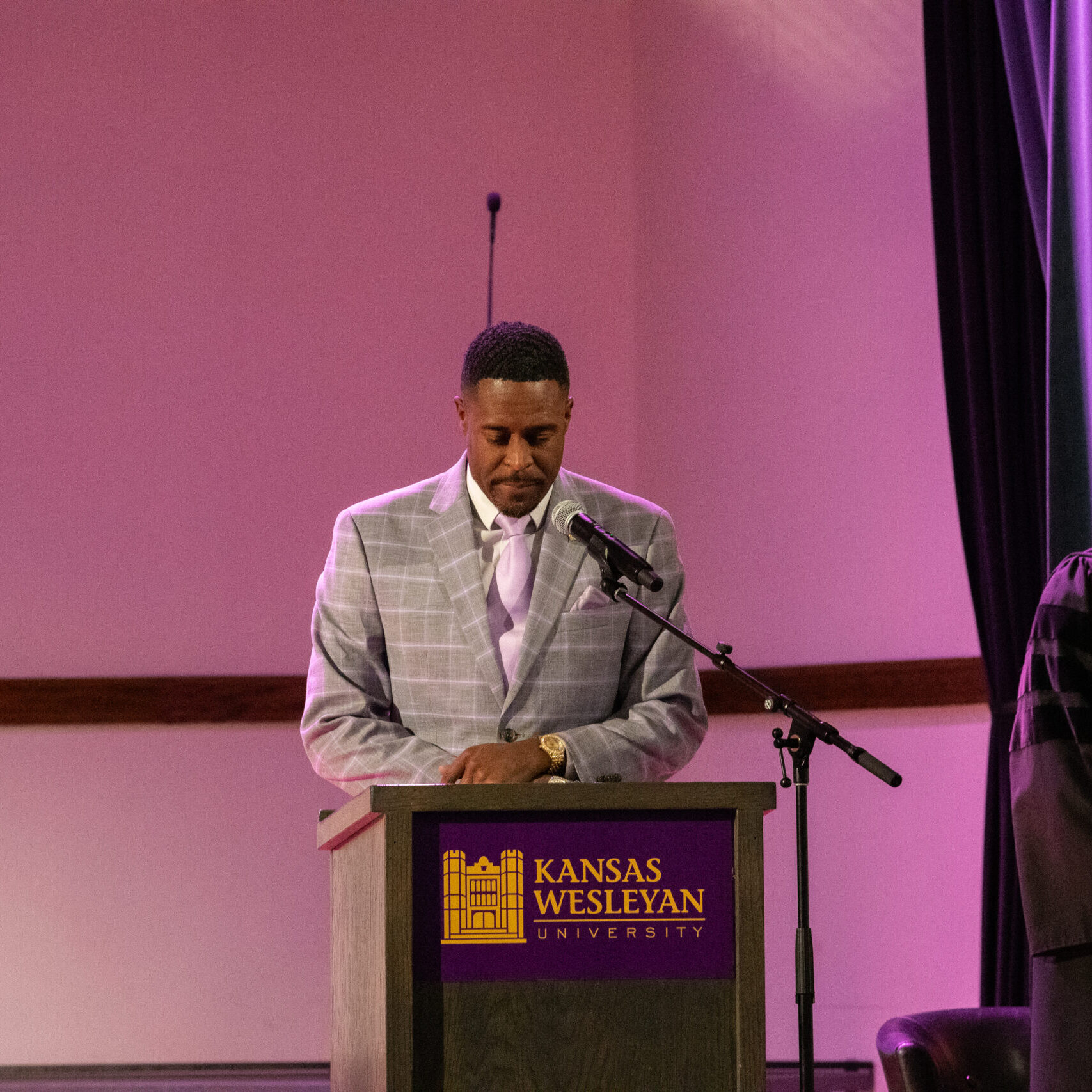 Man praying at podium