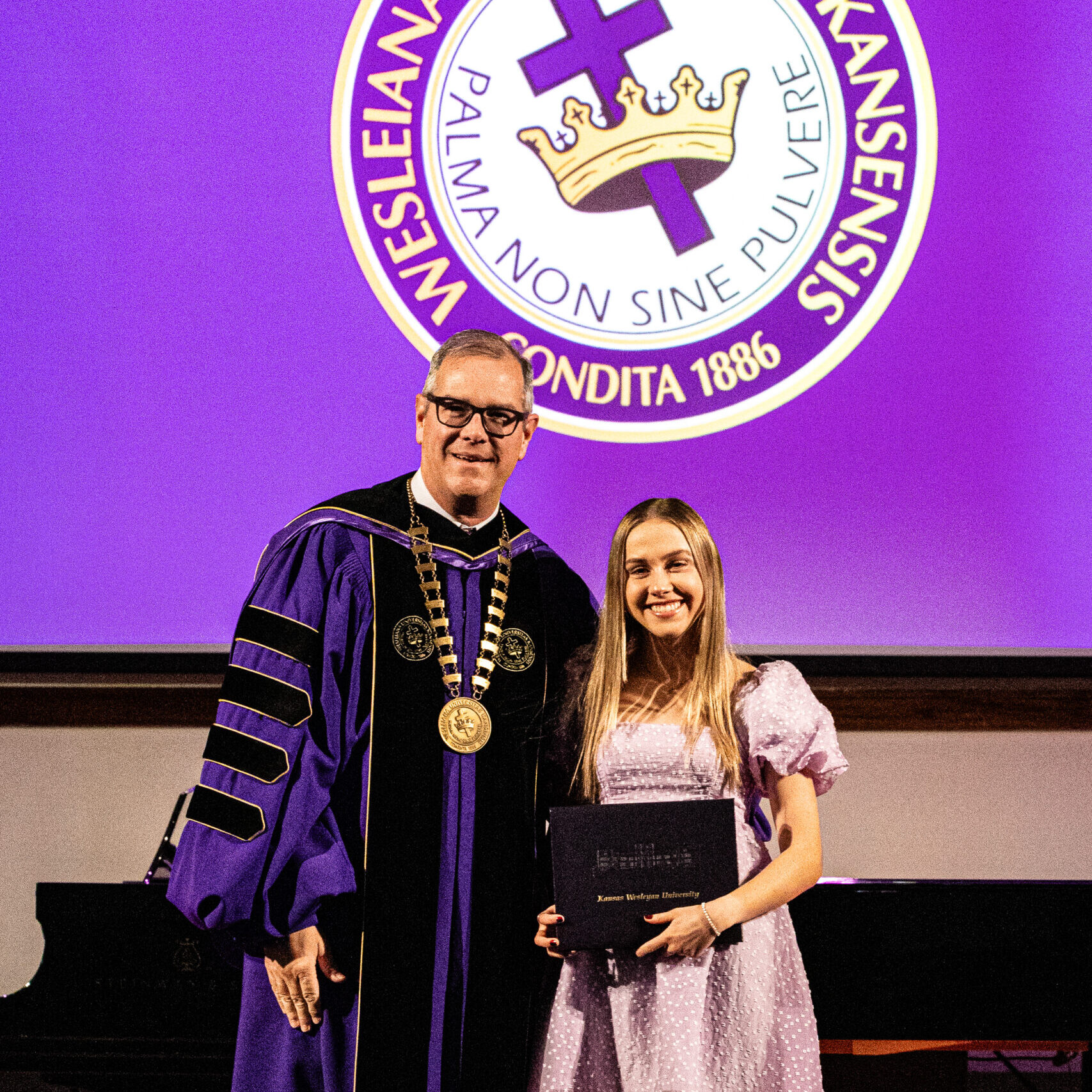 Female graduate with president