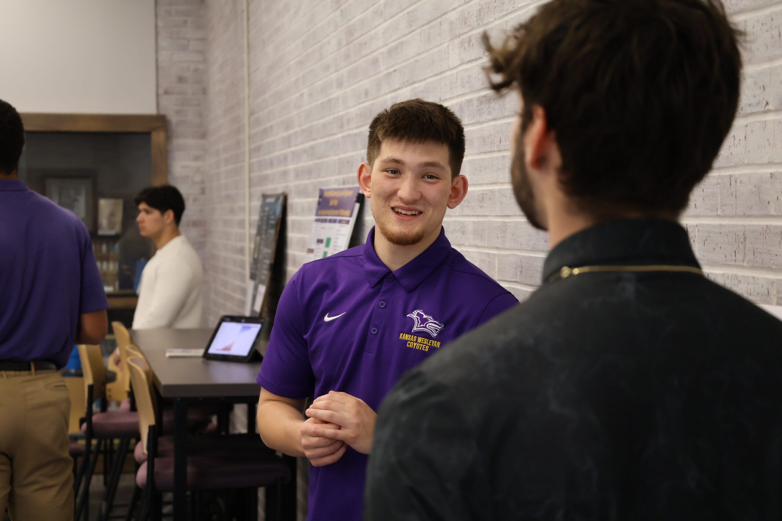 Male student speaking to colleague