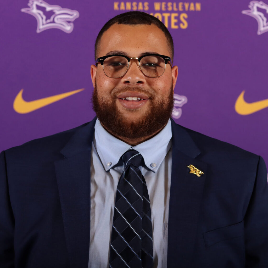 Man in suit with logo next to him