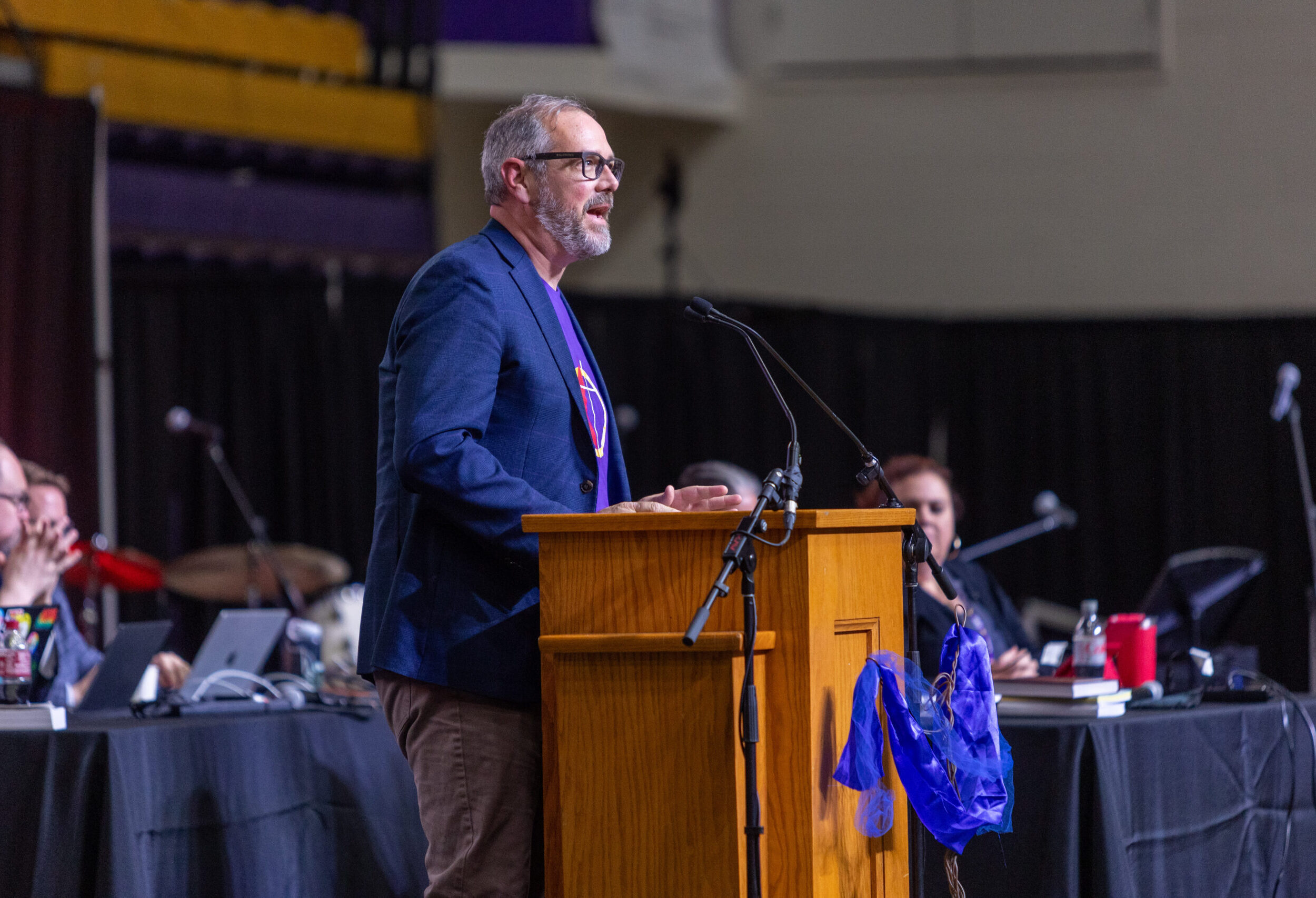 Man speaking from podium to conference
