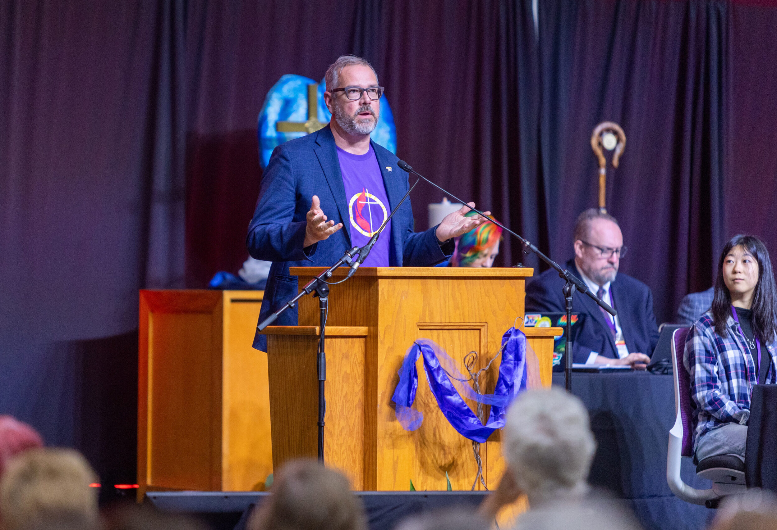 Man speaking from podium to conference