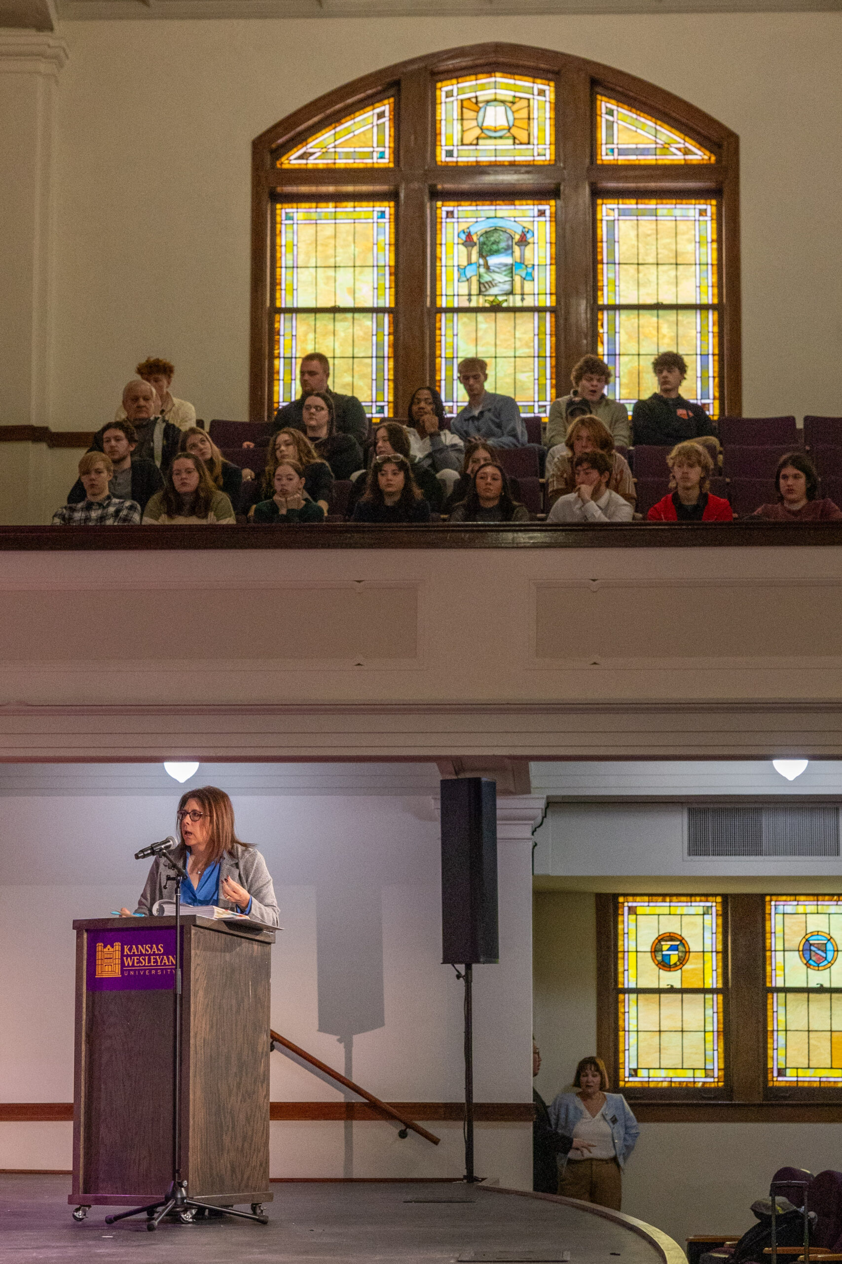 Lawyer presenting to judges with crowd behind