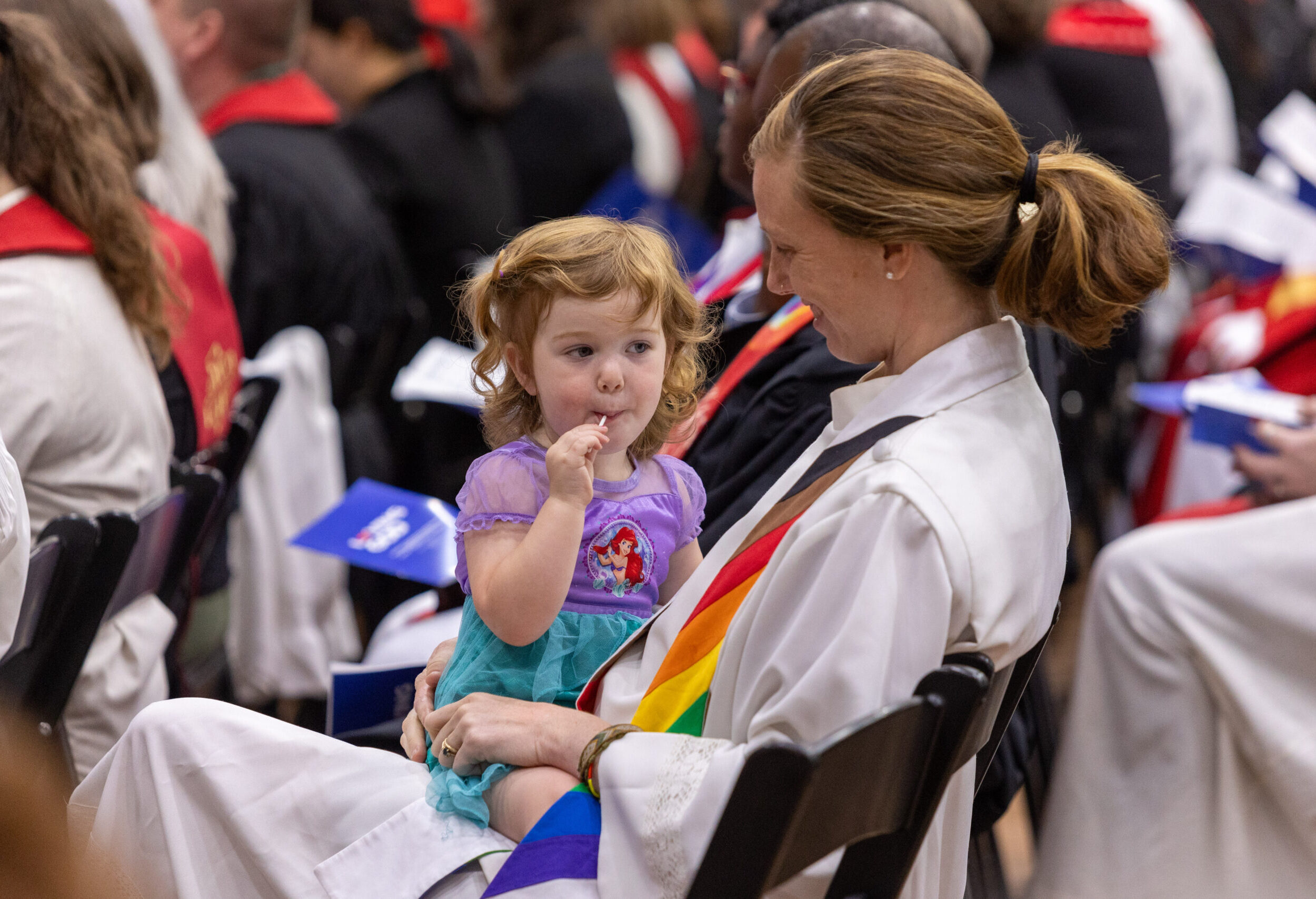 Woman holding child during service